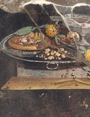 Arheologii au descoperit o pictură care înfățișează „un strămoș al pizzei” într-o casă veche din Pompei